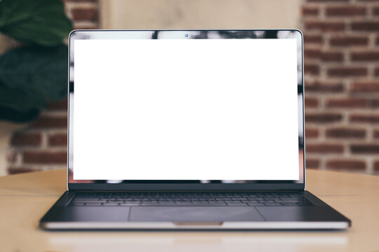 computer blank screen mockup.using laptop with white background for advertising,contact business search information on desk at coffee shop.marketing and creative design