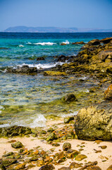 Ocean waves breaking on the rocks on the shore.