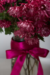 A bouquet of red chrysanthemums on a white background. Close-up shot.