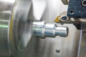 The CNC lathe machine thread cutting the metal shaft part. The hi-accuracy  part manufacturing...