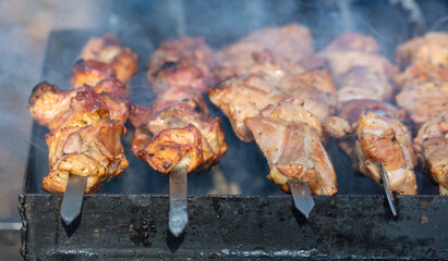 Meat on skewers is fried