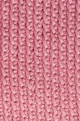 Pink knitted material texture background. Top view. Copy, empty space for text