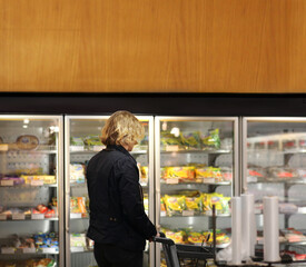 Man choosing frozen food from a supermarket freezer