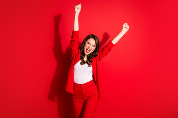 Photo of charming young girl crazy raise two hands knee scream eyes closed wear blazer isolated red...