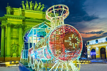 Saint-Petersburg. Colorful locomotive of garlands installed for the New year. Christmas decoration of the city. Narva triumphal gate in green light. Celebrating New year in Russia.