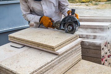 Construction material travertine. Cutting stone with hand power tools