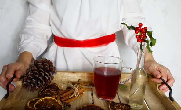 Swedish Sankta Lucia Christmas celebration with woman and tray with mulled wine