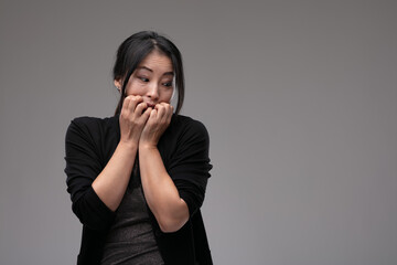 Fearful anxious Asian woman looking to the side