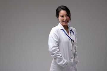 Confident smiling Asian doctor in lab coat