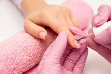 Obraz na płótnie Canvas Close-up of a manicurist who polishing nail's.