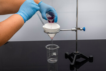 Filter paper in laboratory. Scientists are chemical filtration by filtering through filter paper in...