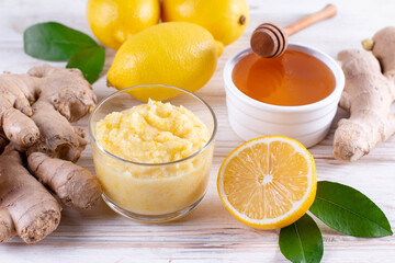 Fall immune system booster - ginger, lemon and honey on a white table