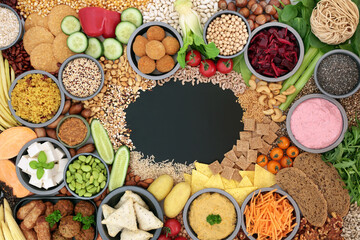 Vegan health food for ethical eating with plant based foods high in antioxidants, protein, fibre, anthocyanins, vitamins, omega 3, smart carbs, lycopene & carotenoids. Blackboard with copy space.