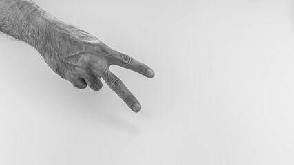 A man with two fingers, Hand gesture peace sign on white background. Two fingers up.
