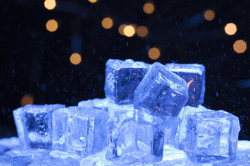 Ice cubes pile with warm lights in the background