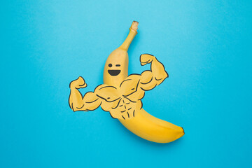 A nutritious banana with muscular arms. A hearty post-workout snack. Healthy food.