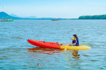 Tourist travel by raft boats to relax and kayaking to watch the red hawks and mangrove forest in...