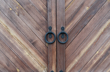 antique wooden door with iron ring handle and lock in the monastery building