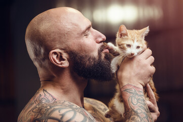 brutal tattooed man with cat