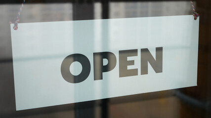 Close-up of a sign on the front door with the inscription OPEN