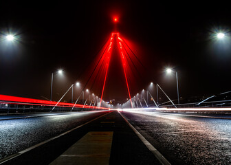 Fototapeta na wymiar Northern Spire Bridge, Sunderland, UK on a misty night and illuminated to commemorate Remembrance Sunday 2020.