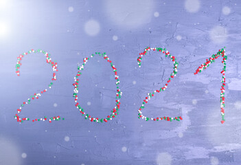 New Year background with sugar sprinkle arranged into 2021 on grey