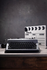 vintage typewriter, camera and movie clapper board
