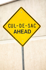 A yellow diamond shaped  traffic sign indicating that a cul de sac is ahead