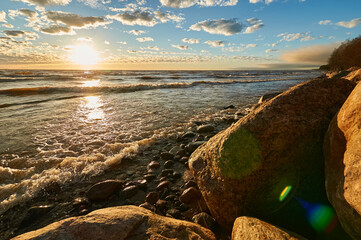sunset by the bay, stones and waves