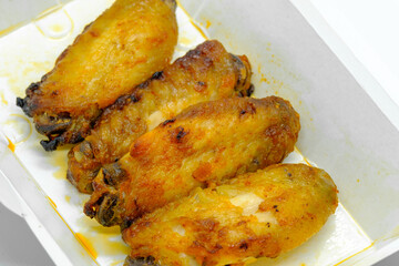 Close-up of Chicken wings in paper box container for take away
