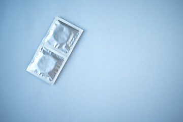 Several condoms on a blue background. The concept of safe sex.