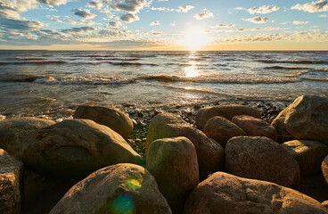 sunset by the bay, stones and waves