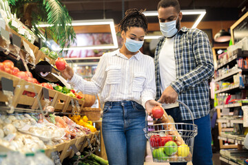 African Family Shopping In Supermarket Buying Vegetables In Grocery Store