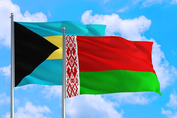 Belarus and Bahamas national flag waving in the windy deep blue sky. Diplomacy and international relations concept.