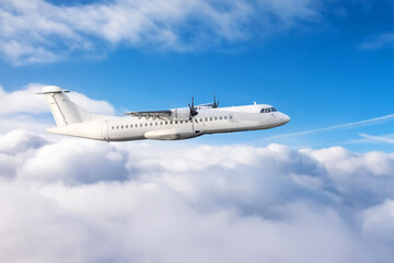 Turboprop plane flies above the clouds passenger flight, aerial view.
