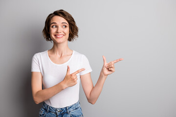Photo of young beautiful woman look point fingers empty space ad promo choice recommend isolated...