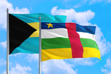 Central African Republic and Bahamas national flag waving in the windy deep blue sky. Diplomacy and international relations concept.