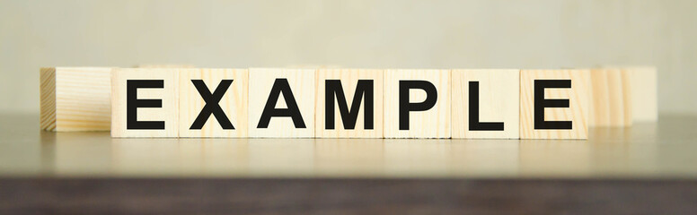 example word written on cubes and black table. Educational marketing or storytelling concept.