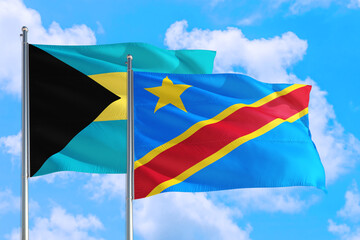 Congo and Bahamas national flag waving in the windy deep blue sky. Diplomacy and international relations concept.