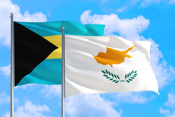 Cyprus and Bahamas national flag waving in the windy deep blue sky. Diplomacy and international relations concept.