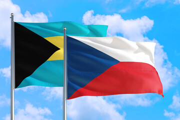 Czech Republic and Bahamas national flag waving in the windy deep blue sky. Diplomacy and international relations concept.