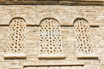 Patterned stone windows of medieval building in Baku, Azerbaijan
