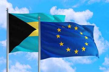 European Union and Bahamas national flag waving in the windy deep blue sky. Diplomacy and international relations concept.
