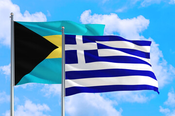 Greece and Bahamas national flag waving in the windy deep blue sky. Diplomacy and international relations concept.