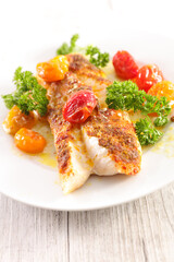 fish fillet with baked tomato and herb