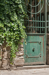Old vintage retro weathered metal green door of house garden