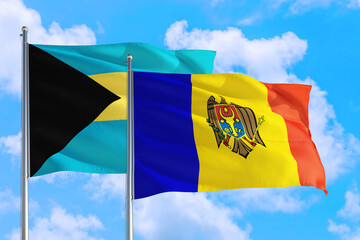 Moldova and Bahamas national flag waving in the windy deep blue sky. Diplomacy and international relations concept.