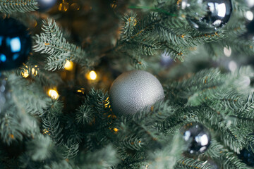 Obraz na płótnie Canvas New Year 2020. Christmas beautiful lights on dark cold background. Defocused lights on a tree background. Gray Christmas toy. abstract, blinking, blurred, soft focus, out of focus, blur.