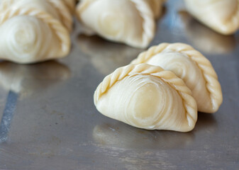 Image selective focus  samosas or double curry separated as food or dessert snack have a delicious and spicy taste made from bread blue background.