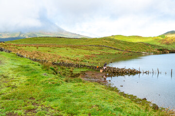 Azores, the mountain Lake "Lagoa do Capitao" in the highlands of Pico Island, in the background the Pico mountain. 